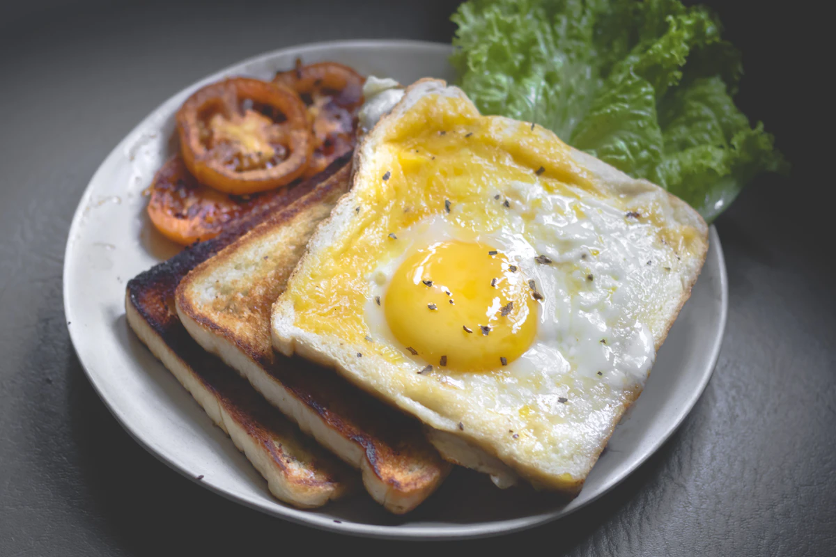 Breakfast plate with fried egg on toast and tomatoes