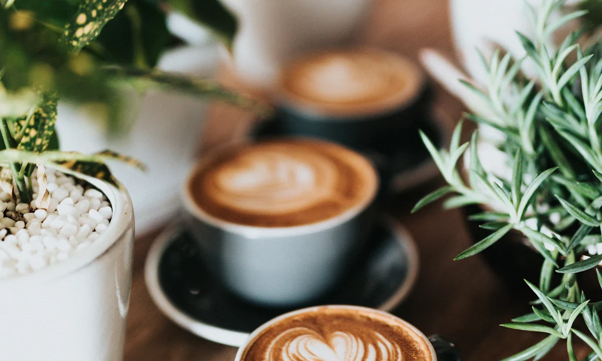 Cups of latte with foam art on a cafe table
