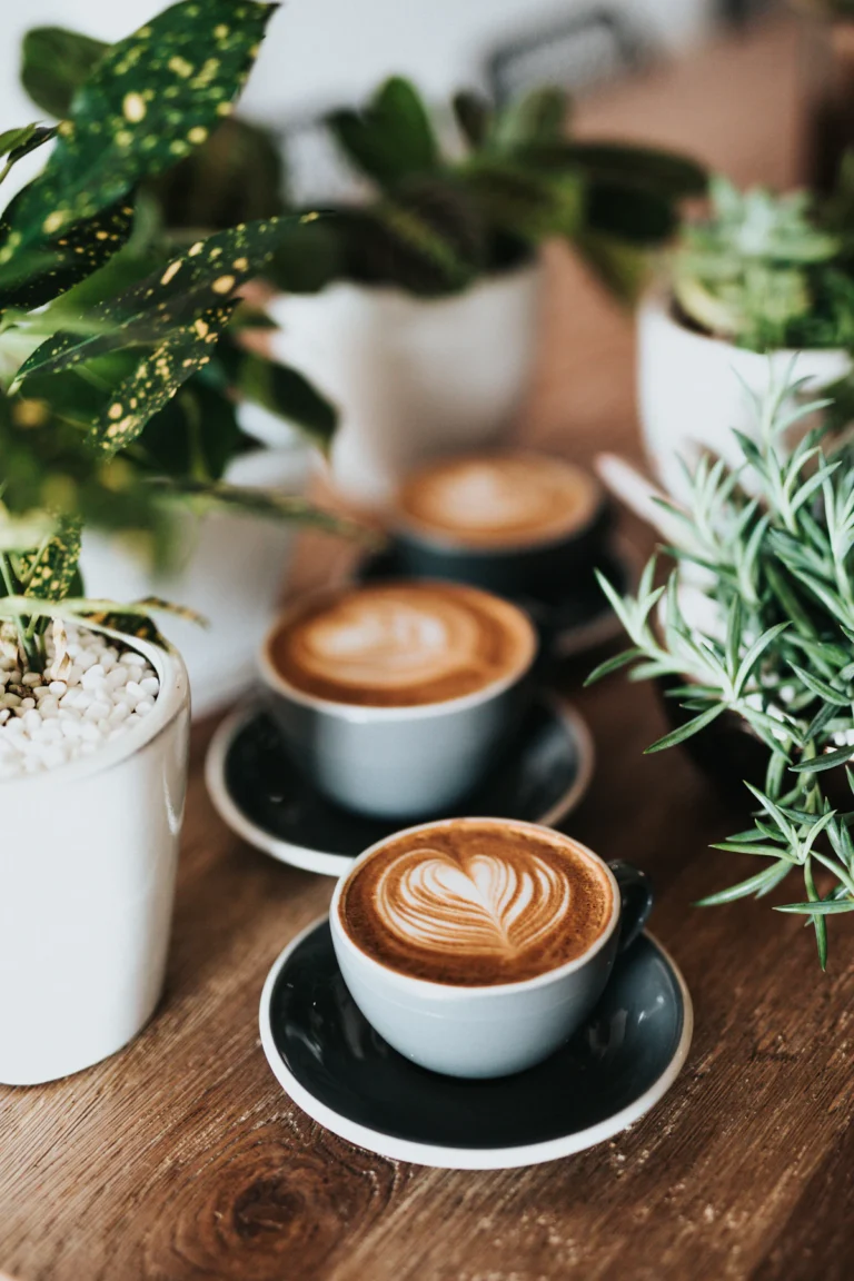 Cups of latte with foam art on a cafe table