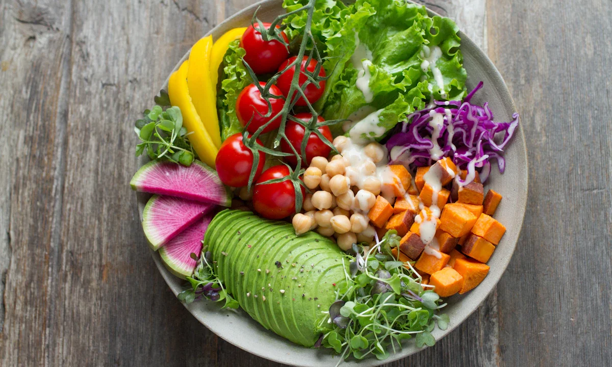 Fresh salad bowl with avocado, greens and vegetables