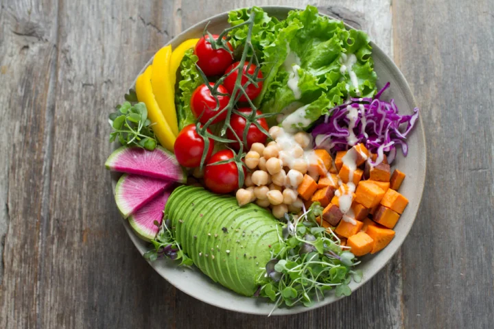 Fresh salad bowl with avocado, greens and vegetables