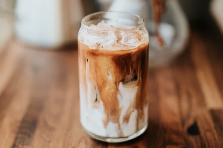 Iced latte in a glass on a wooden counter