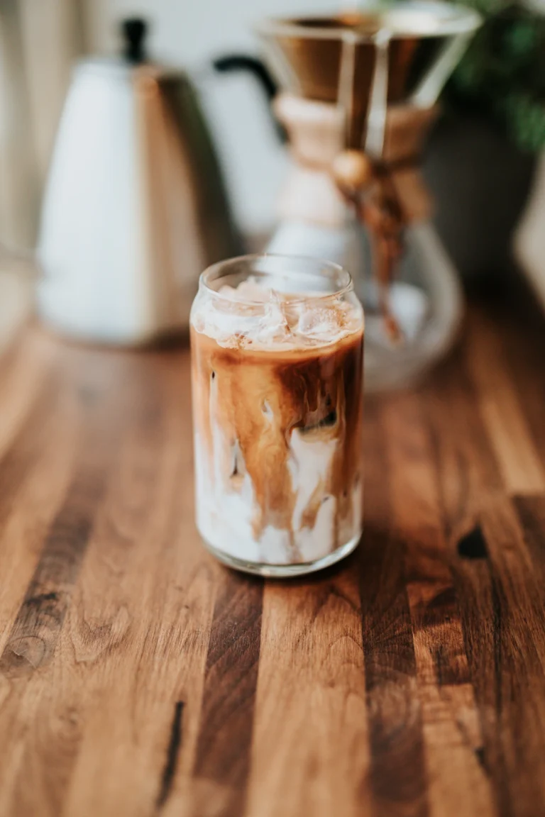 Iced latte in a glass on a wooden counter